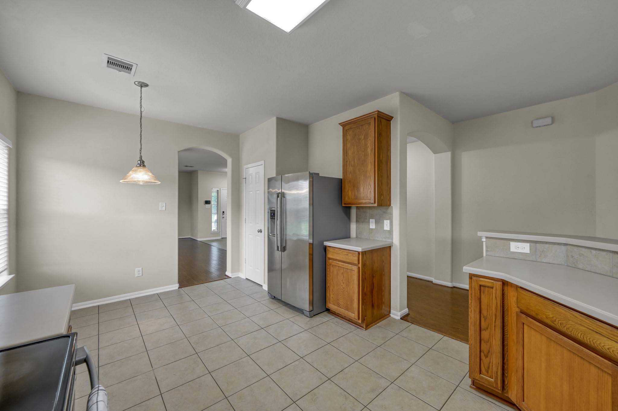 631 Timberstand Lane Spring, TX 77373 - Photo 16 of 38 Designed with functionality in mind, the kitchen offers ample cabinet space, a pantry, and easy-care tile flooring.