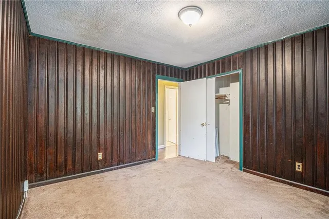 a view of an empty room with wooden walls