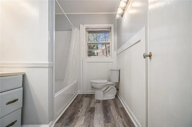 a bathroom with a toilet and a shower