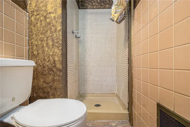 a bathroom with a toilet and shower