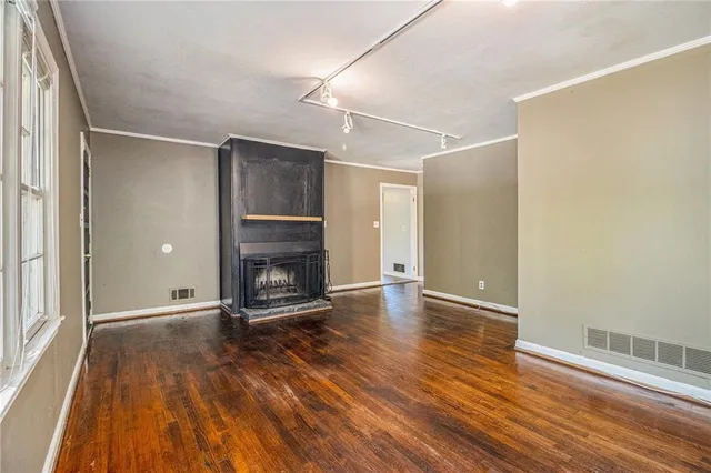 a view of a room with wooden floor and a fireplace