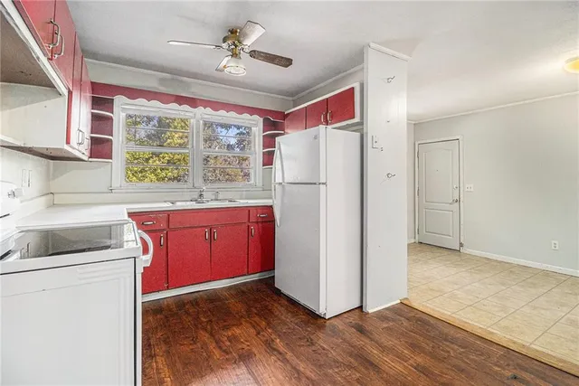 a kitchen with a refrigerator a stove a sink and a window