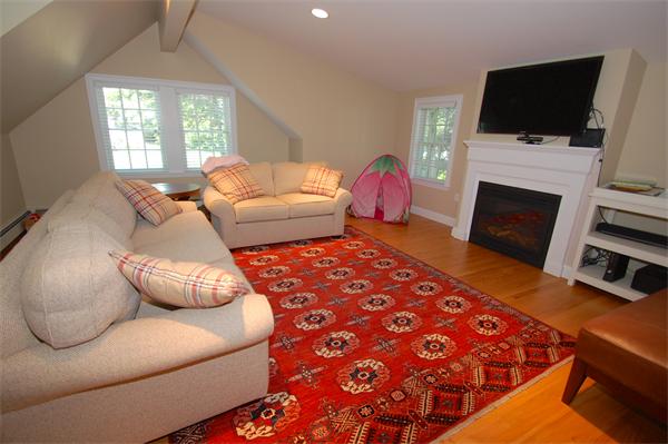 127 Grosvenor Road Needham, MA 02492 - Photo 16 of 21 a living room with furniture a flat screen tv and a fireplace