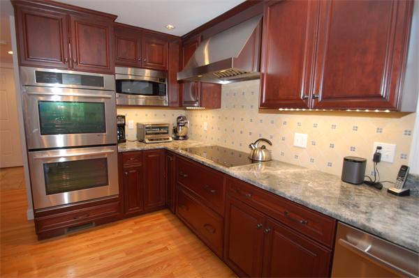 127 Grosvenor Road Needham, MA 02492 - Photo 4 of 21 a kitchen with stainless steel appliances granite countertop a sink stove and cabinets