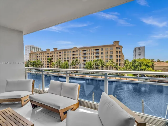 a view of a chairs and table in a balcony