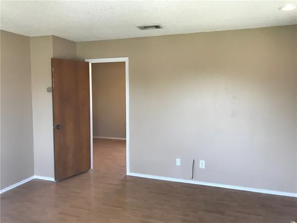 an empty room with closet and a window