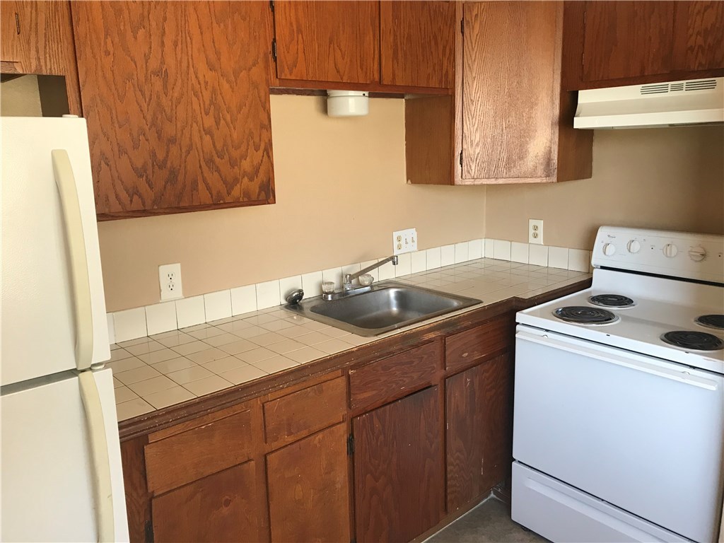 1638 Post Road, Unit B San Marcos, TX 78666 - Photo 3 of 6 a kitchen with a sink a stove and a refrigerator