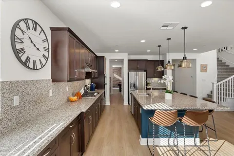 a large kitchen with a table and chairs