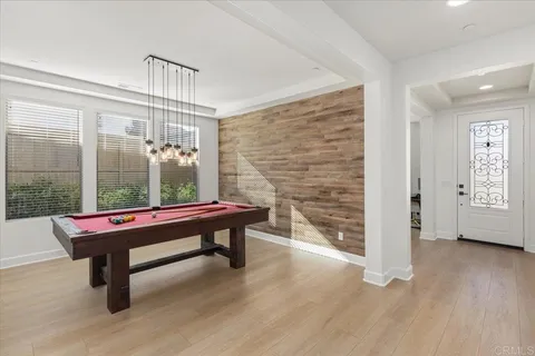 a room with pool table and windows