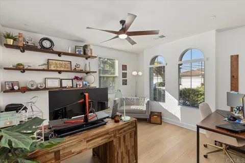 a view of a livingroom with workspace and a window