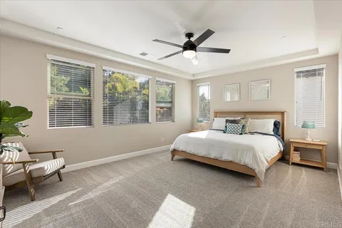 a spacious bedroom with a bed and a window