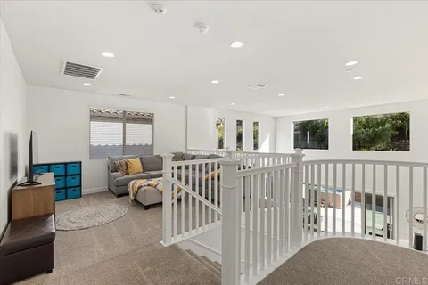 a living room with white furniture
