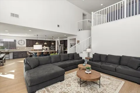 a living room with furniture and a ceiling fan