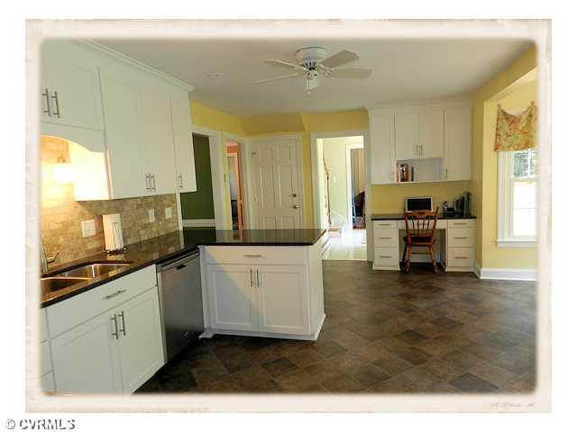 8628 Trabue Road Richmond, VA 23235 - Photo 6 of 24 Kitchen - A completely renovated kitchen with granite counters, new cabinets, new stainless steel appliances, new flooring, tile backsplash.