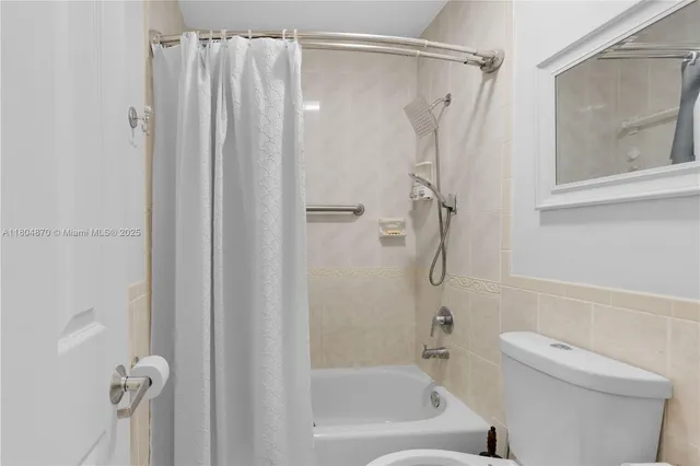 a bathroom with a shower a toilet and a shower