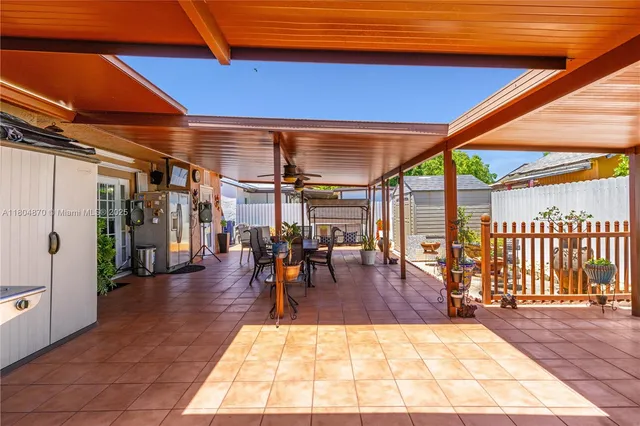 a view of a patio with table and chairs and potted plants