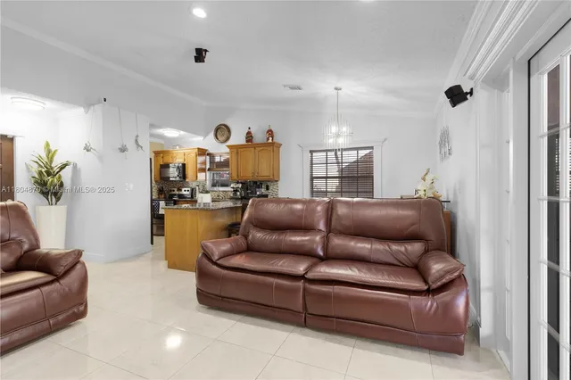 a living room with furniture and kitchen view