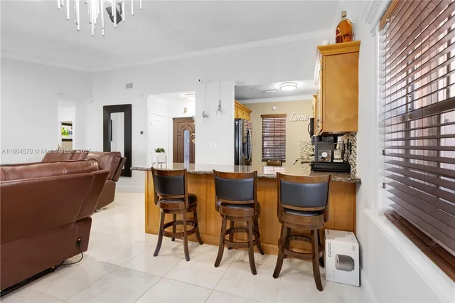 a dining room with furniture and a kitchen view