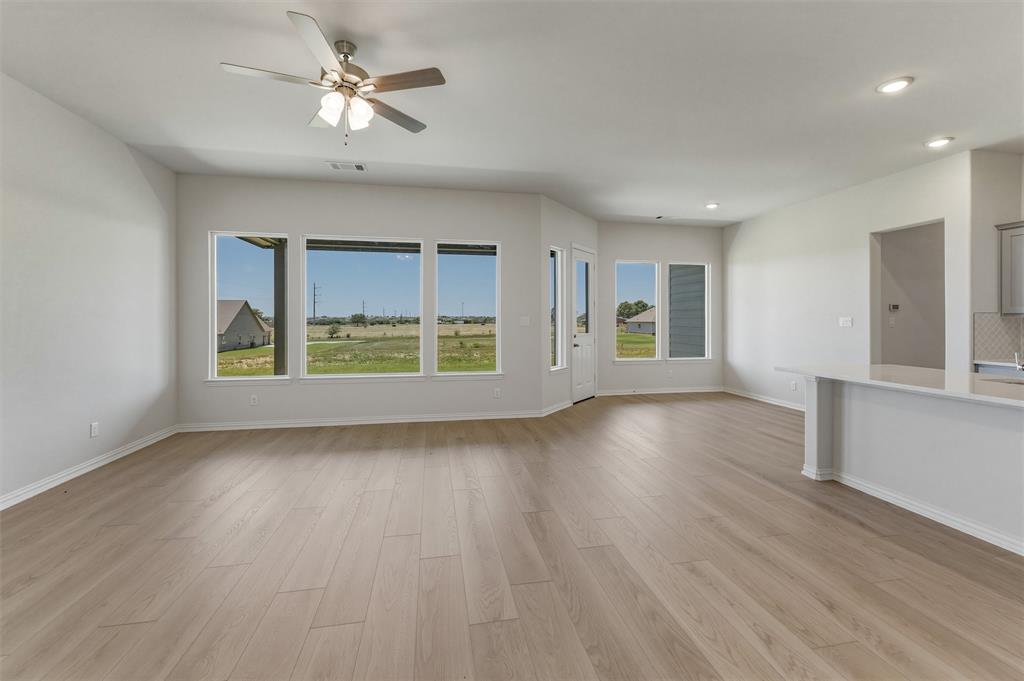 114 Hillview Trail Decatur, TX 76234 - Photo 6 of 27 Spacious interior room featuring wood-finish flooring, a ceiling fan with integrated lighting, recessed lighting, and multiple windows
