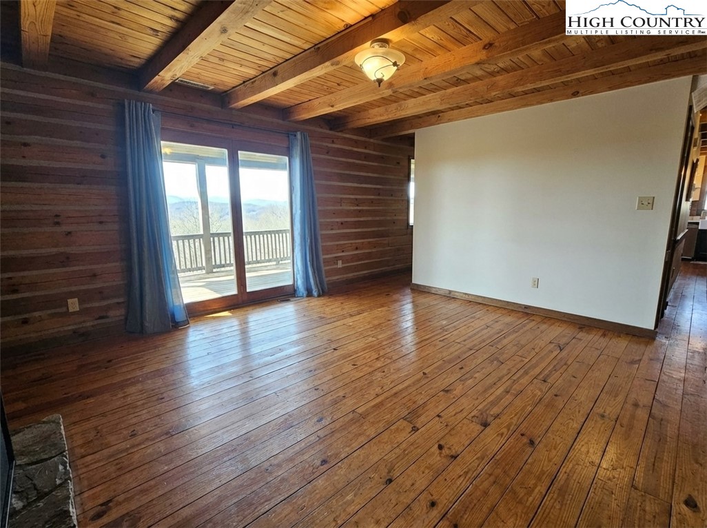 480 Schoolhouse Ridge Boone, NC 28607 - Photo 12 of 47 a view of an empty room with wooden floor and window