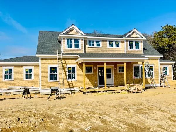 a front view of a house with yard and seating space