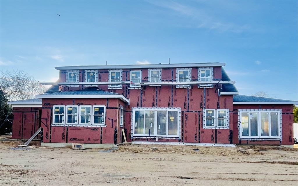 7 Martha's Way Edgartown, MA 02539 - Photo 4 of 6 a view of a brick house with large windows