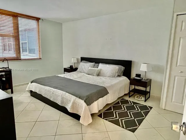 a bathroom with a granite countertop sink toilet and mirror
