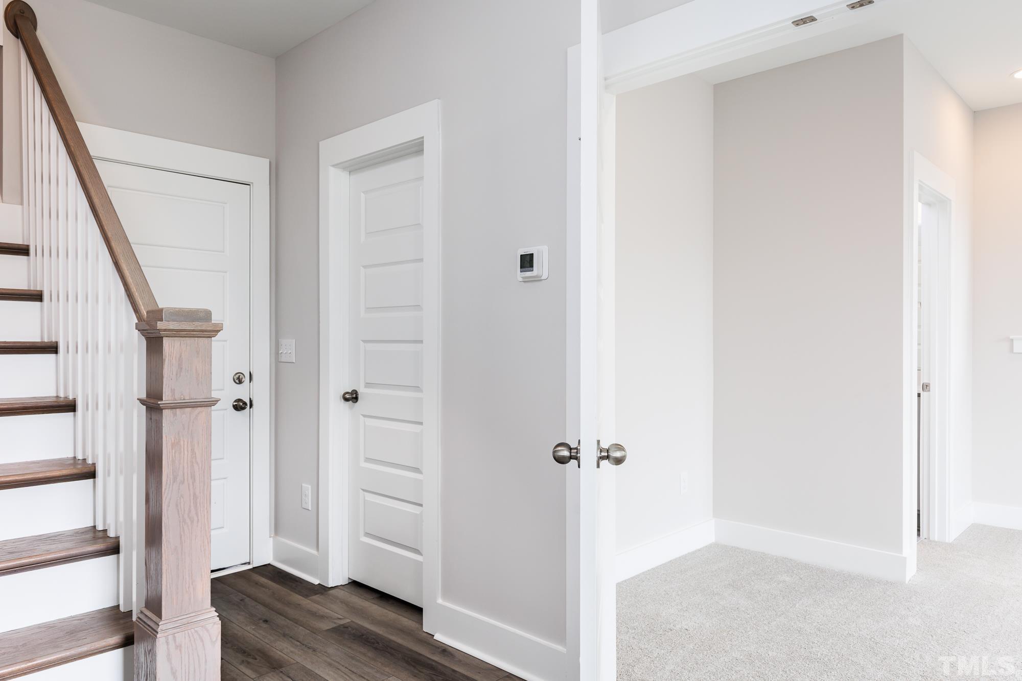 8525 Marvino Lane Raleigh, NC 27613 - Photo 1 of 24 a view of a hallway with wooden floor and entryway