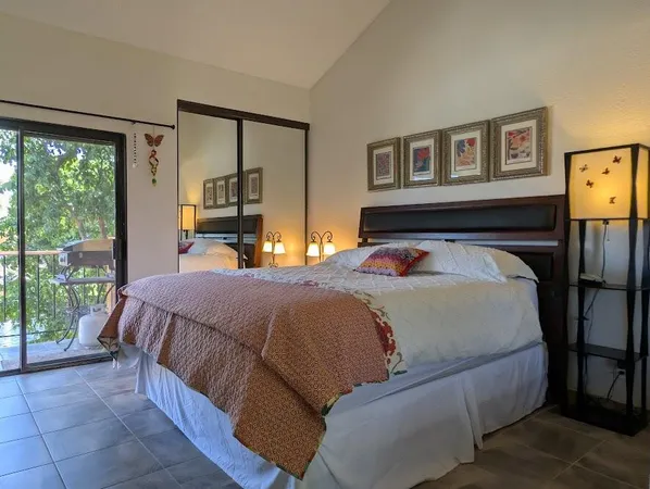 a bedroom with a large bed and a large window