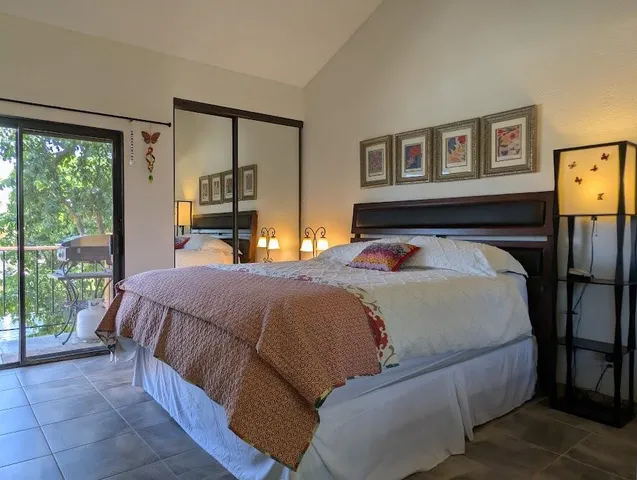 a bedroom with a large bed and a large window