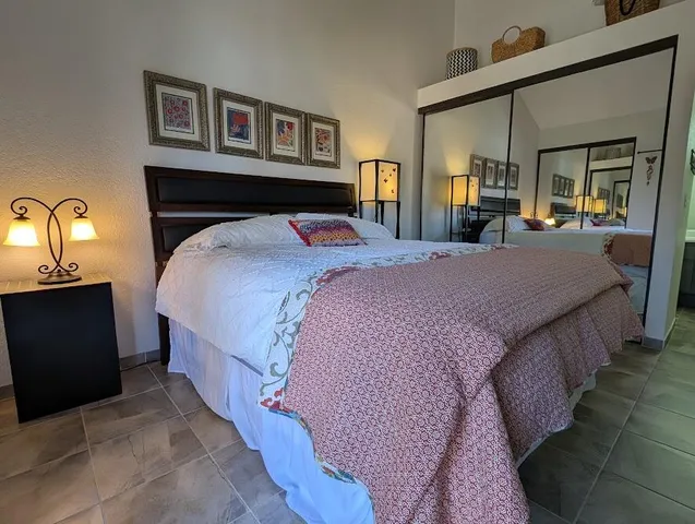 a bedroom with a bed and a chandelier