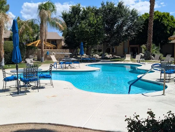 a swimming pool with outdoor seating and covered outdoor space