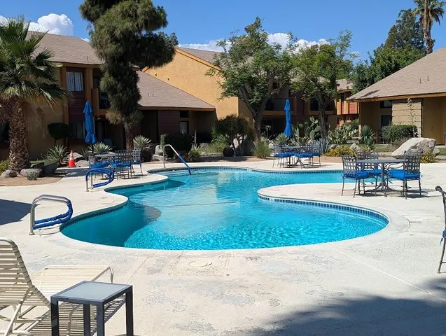 a view of a house with swimming pool and sitting area