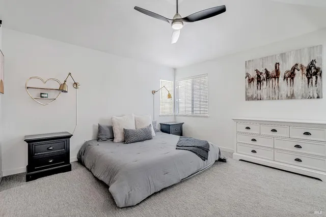 a bedroom with a bed and a painting on the wall