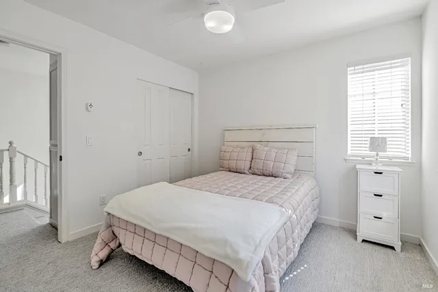 a bedroom with a bed and a window