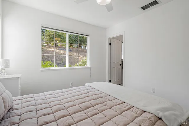 a bedroom with a bed and a window