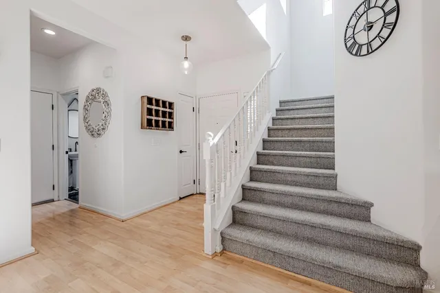 a view of entryway with stairs and a chandelier