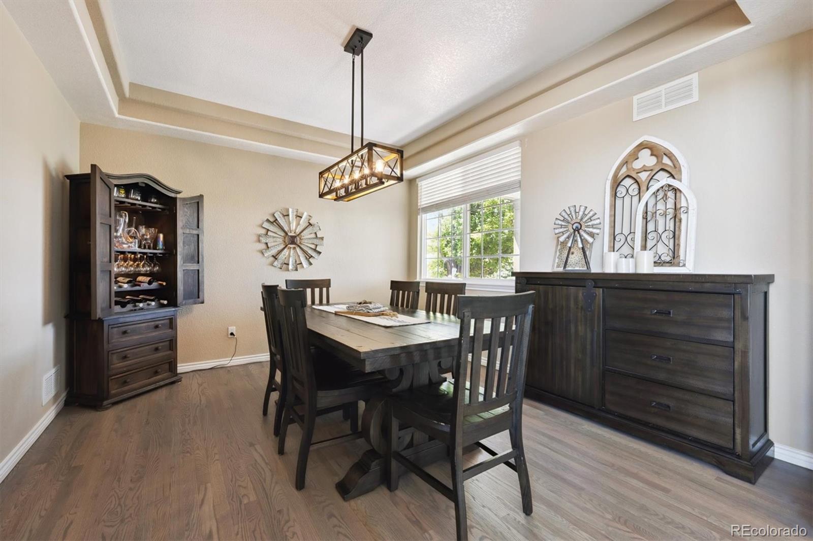 724 Imboden Road Watkins, CO 80137 - Photo 10 of 50 a view of a dining room with furniture window and wooden floor