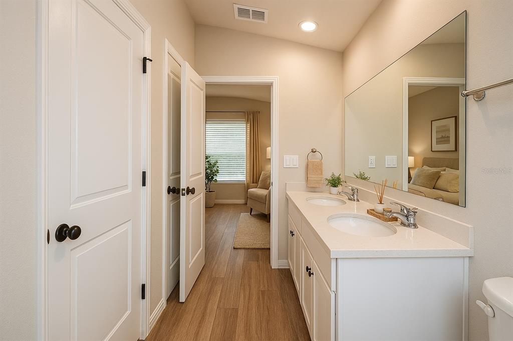46 Ash Road Ocala, FL 34472 - Photo 12 of 20 a bathroom with a double vanity sink a mirror and a shower