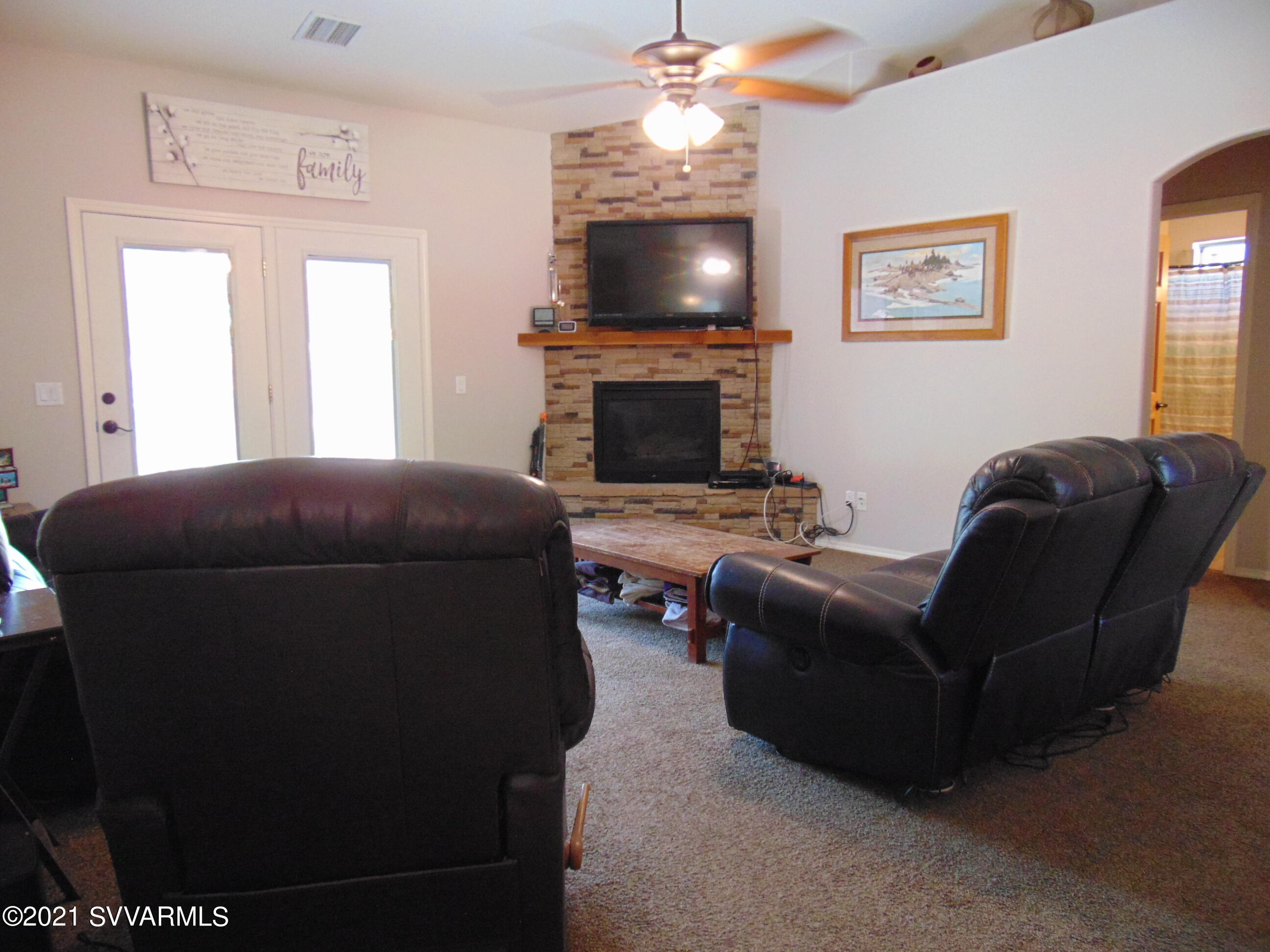 3995 East Beaver Vista Road Rimrock, AZ 86335 - Photo 7 of 40 a living room with furniture a flat screen tv and a fireplace