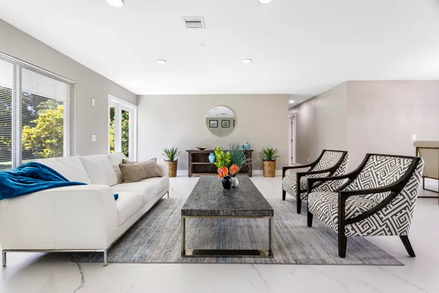 a view of a dining room with furniture and a potted plant