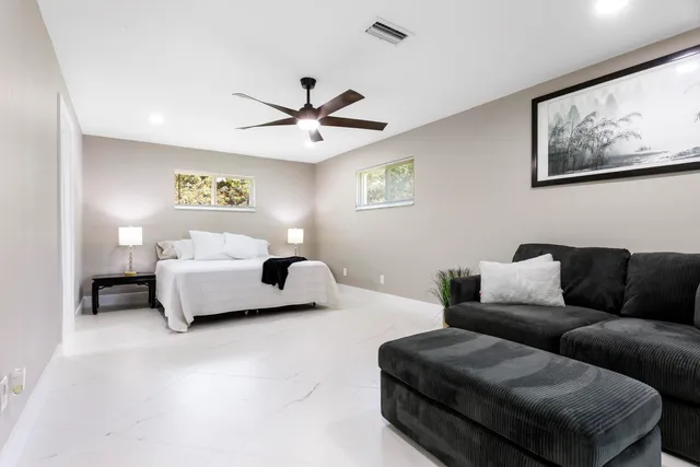 a bedroom with bed and a couch