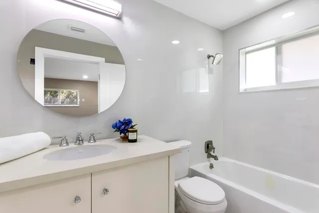 a bedroom with furniture and a ceiling fan
