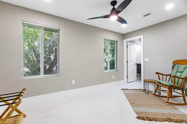 a bedroom with a bed and painting on the wall