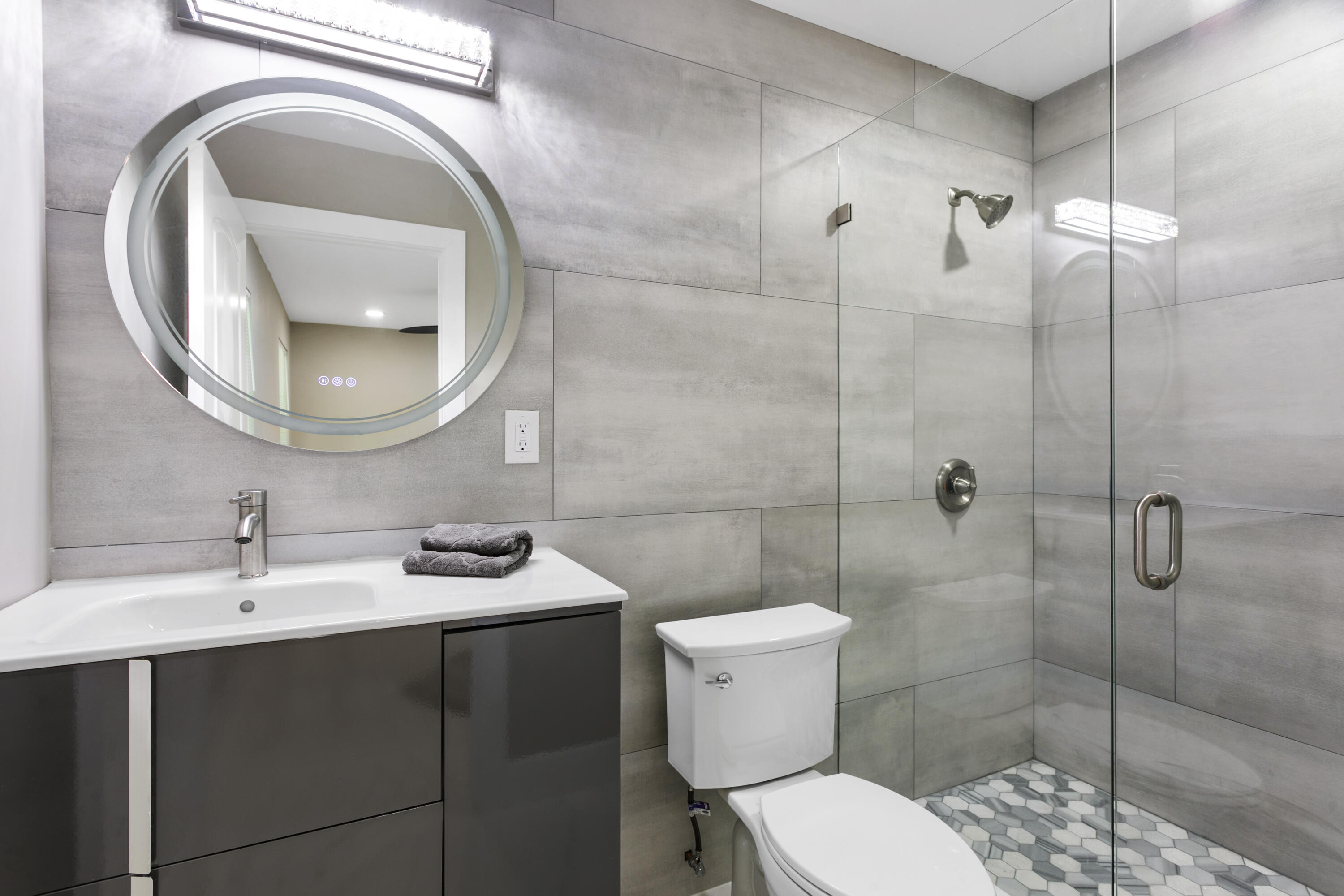 5200 Club Road Haverhill, FL 33415 - Photo 27 of 33 a bathroom with a sink a toilet and a mirror