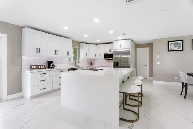 a kitchen with appliances cabinets and furniture
