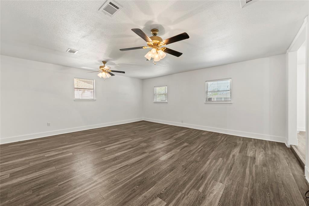 104 East Santa Anna Street Robinson, TX 76706 - Photo 22 of 36 wooden floor in an empty room with a window