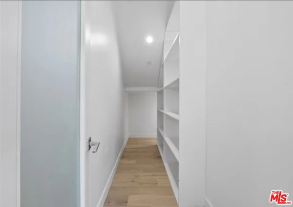a view of a hallway with white walls