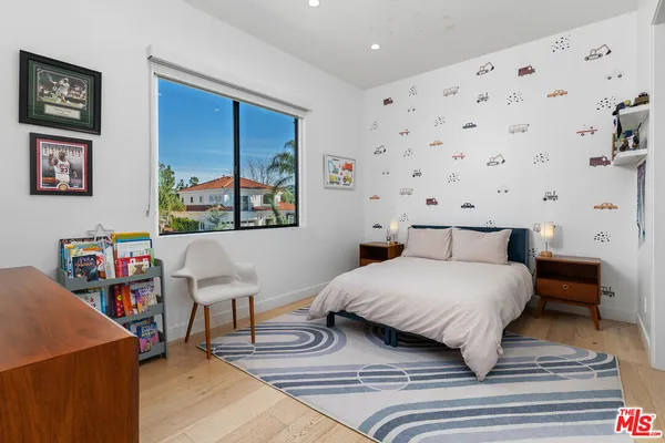 a bedroom with a bed and a dresser in it