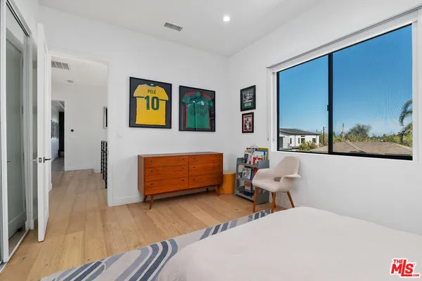 a bedroom with a bed and a dresser